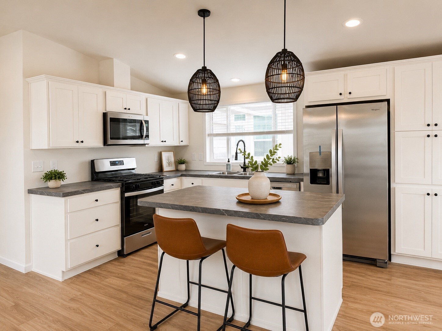 Model kitchen with island seating and pendant lighting at Crystal Mountain MHC