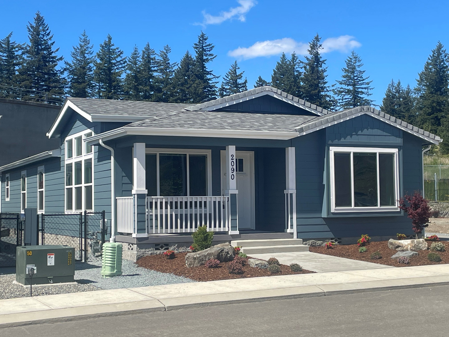 blue suburban home with front porch