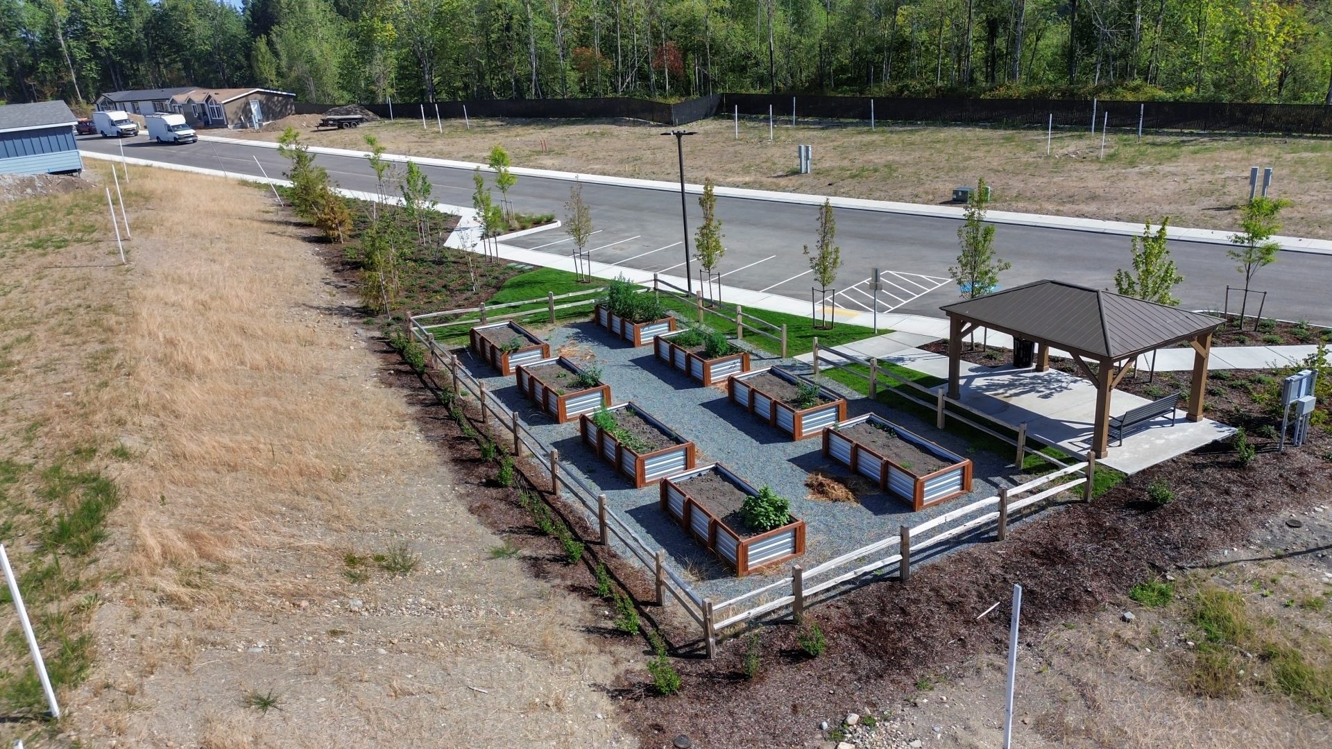 fenced community garden with pavilion