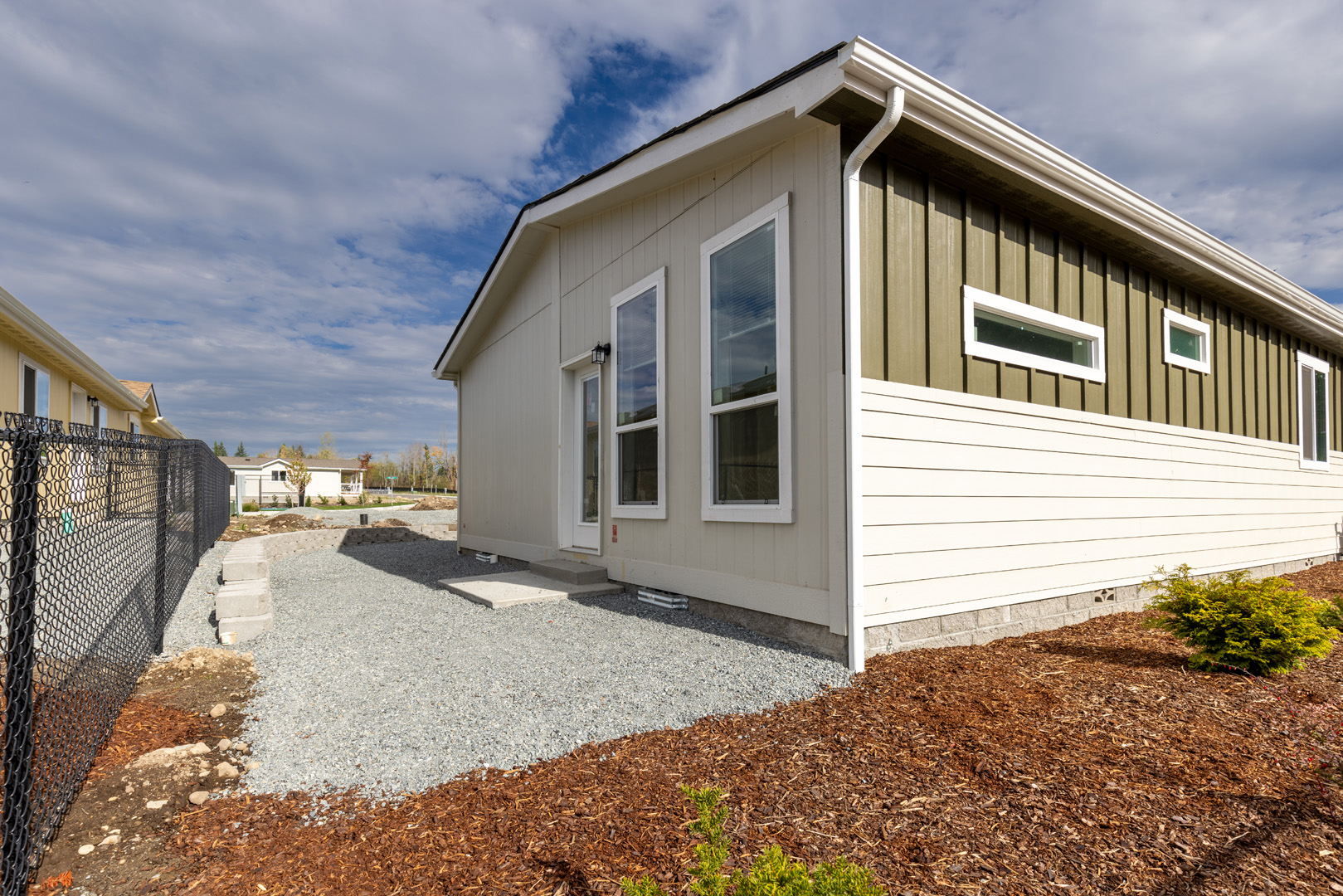 modular house side exterior and gravel