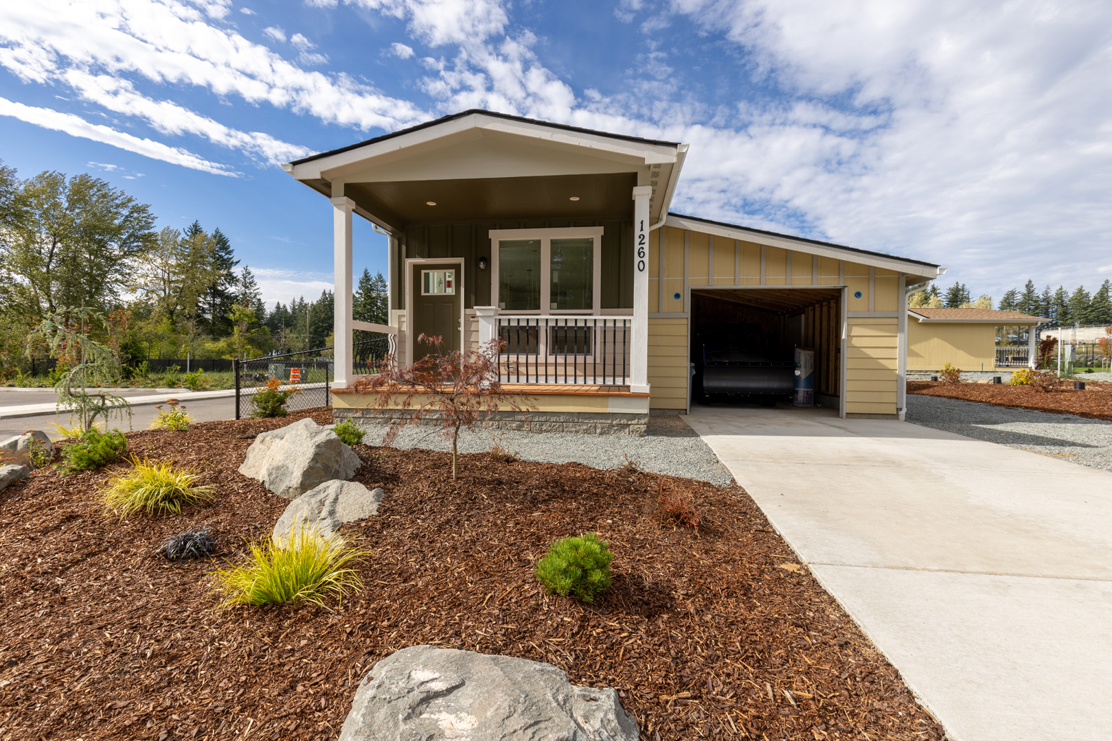 olive green dwelling with attached garage