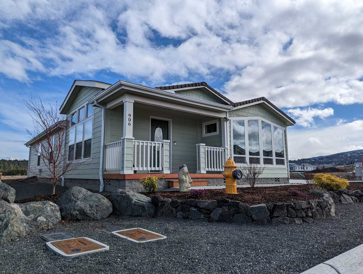sage green modular residence facade