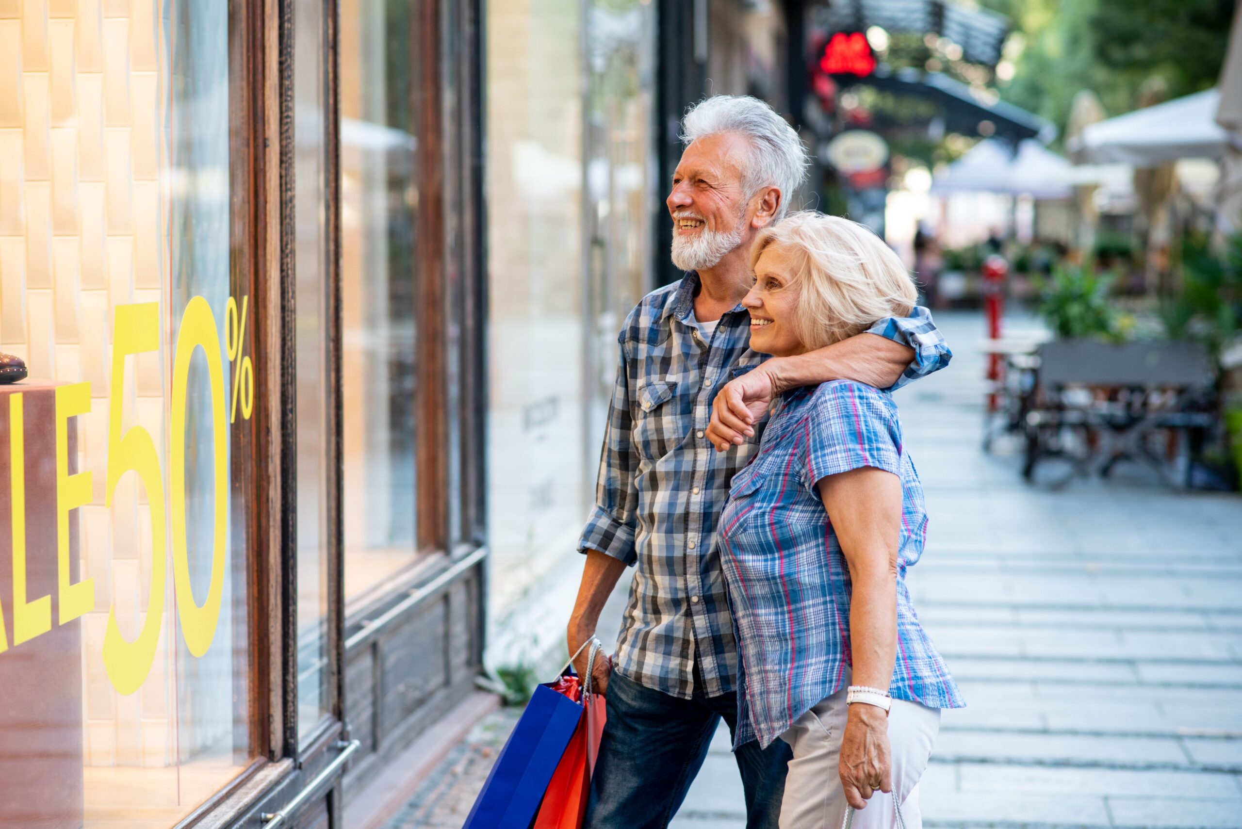 senior couple window shopping outdoors scaled