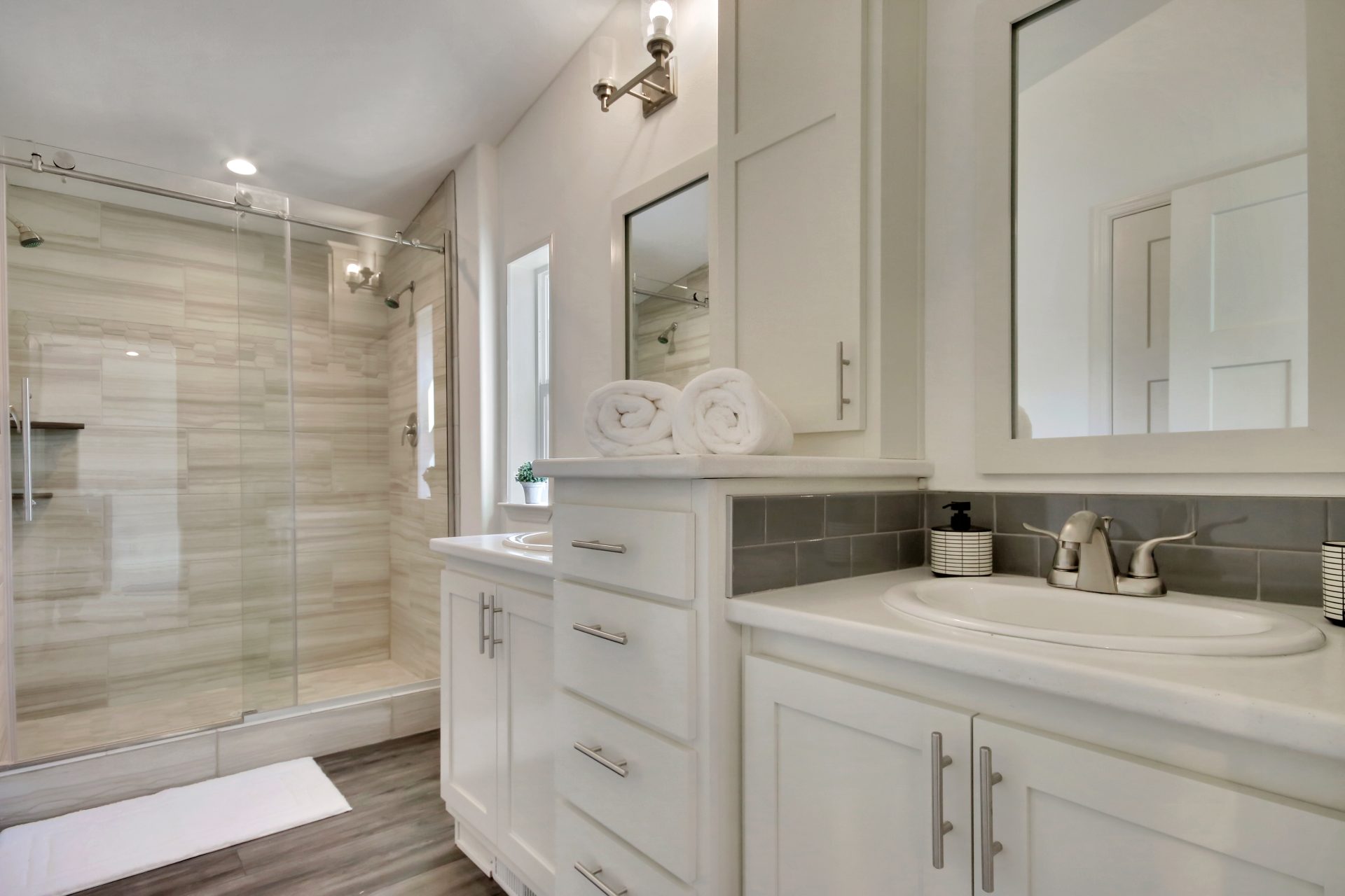 split white vanity and tiled shower